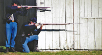 Taking cover behind the barn