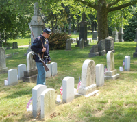 reading one of the many Civil War graves