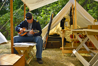 the Captain strums his mandolin