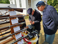 helping Pvt. Barboza with his musket