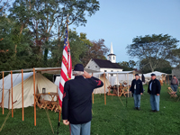 Saluting the raising of the colors
